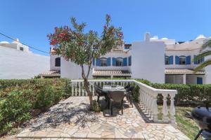 a house with a table and chairs in front of it at Vila Mourisca in Armação de Pêra