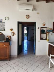 a hallway with a door leading to a room with a kitchen at Casa DAFNE in Lipari