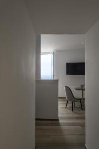 a white room with a table and a chair and a table at Sublimis Boutique Hotel Adults-Only in Camogli