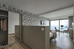 a bedroom with a bed and a view of the ocean at Sublimis Boutique Hotel Adults-Only in Camogli