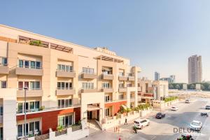 an apartment building with a street in front of it at Artsy Studio at Shamal Waves JVC by Deluxe Holiday Homes in Dubai