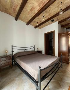 a bedroom with a bed and a wooden ceiling at La Vie En Rose in Fondi