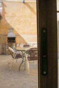 a close up of a door with a table and chairs at Vivienda Turistica El Caneco in Tordesillas