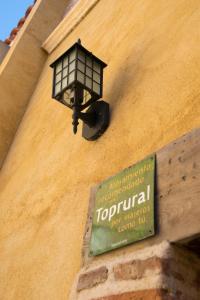 a street light on the side of a building with a sign at Vivienda Turistica El Caneco in Tordesillas
