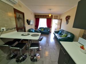 a kitchen and living room with a table and a couch at Sherwood Forest 2 Marina Drive in Southbroom