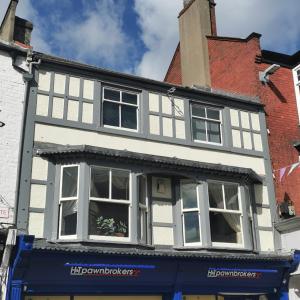 a white building with white windows on a street at Huge 6-Bed Apartment in Darlington Centre in Darlington