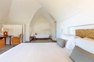 A bed or beds in a room at Pantelleria Dream Resort