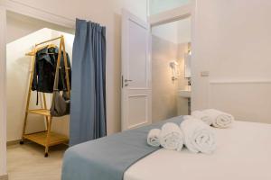 a bedroom with a bed with towels on it at Palazzo Borgomonte - holiday home in Otranto