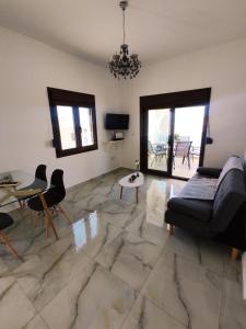 a living room with a couch and a table and chairs at Via Ferrata Houses in Kalymnos