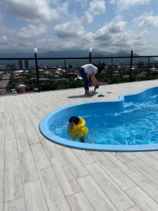 a woman and a child in a swimming pool at Hotel Royal Georgia in Batumi