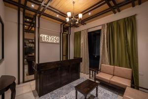 a dressing room with a couch and a mirror at Triose Boutique Hotel Lonavala in Lonavala