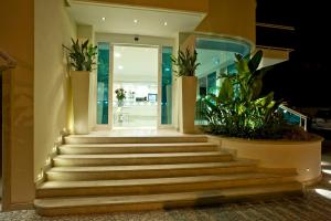 a set of stairs in a building with plants at Hotel Prater in Grottammare