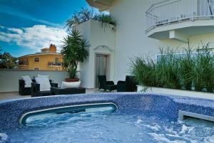 a hot tub on the balcony of a house at Hotel Prater in Grottammare
