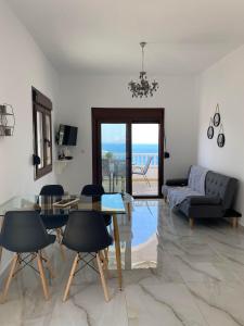 a living room with a table and chairs and a couch at Via Ferrata Houses in Kalymnos