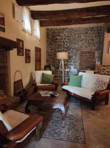 a living room with furniture and a stone wall at Le vigne sull’Adda in Bottanuco