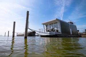 a boat is docked at a dock in the water at Blackbird in Biddinghuizen