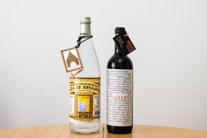 two bottles of wine sitting on a table at Hotel ROIG in Benasal