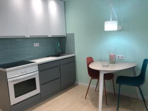 a kitchen with a table and a table and chairs at Villa Mar First line Playa Las Americas in Adeje