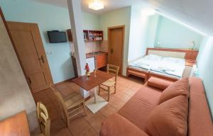 a living room with a couch and a bed at Penzion Schwarzenberský seník in Třeboň