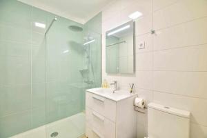 a bathroom with a toilet and a sink and a shower at Timeless Sea I Apartment in Armação de Pêra