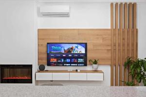 a living room with a tv and a fireplace at Timeless Sea I Apartment in Armação de Pêra