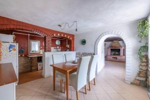 a kitchen and dining room with a table and chairs at Holiday house Ruba in Marčana +21 photos