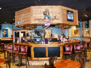 a bar with a bunch of chairs and tables at Boardwalk Beach Hotel in Panama City Beach