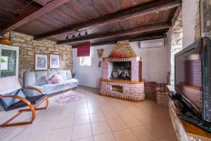 a living room with a couch and a fireplace at Holiday house Ruba in Marčana