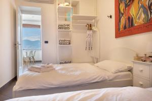a bedroom with two beds and a view of the ocean at Residence La Mignon Oleandri in Torri del Benaco