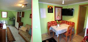 a kitchen and a living room with a table and a couch at Zimmervermietung Leuba in Ostritz