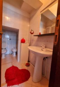 a bathroom with a sink and a toilet at Casa Valentini in San Giuliano Terme