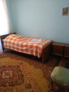 a bedroom with a bed with a plaid blanket at Guest House Armina in Yerevan