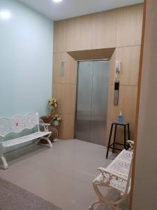 un pasillo del hospital con una sala de espera con dos sillas en SP Residence, en Nakhon Phanom