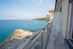 a balcony with chairs and a view of the ocean at La Dimora sul Mare in Marina di Camerota