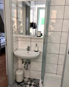 a bathroom with a sink and a mirror at Casa David in Piran +9 photos
