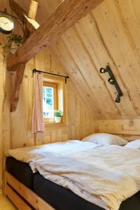 a bedroom with a large bed in a attic at Chata "Na pohodu" in Chřibská