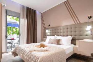 a bedroom with a large bed with a hat on it at Denisa Studios in Sarti