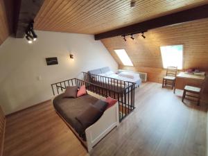a bedroom with two beds and a couch in a room at Black Forest Living - Todtnauberg in Ennerbach