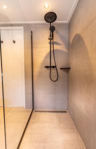 a shower in a room with a glass wall at B&B Duinhuys in Domburg