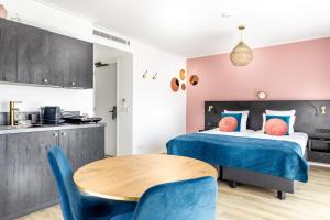 een slaapkamer met een bed en een tafel en stoelen bij B&B Duinhuys in Domburg