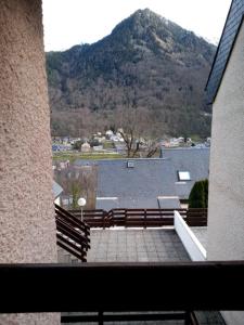 a view from a balcony of a building with a mountain at Joli petit appartement au calme, refait à neuf, avec linge de maison fourni in Cauterets