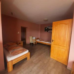 A bed or beds in a room at IKSZT Vendégház