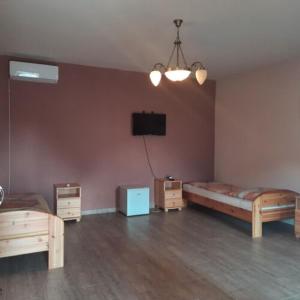 A bed or beds in a room at IKSZT Vendégház