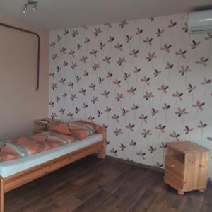 A bed or beds in a room at IKSZT Vendégház