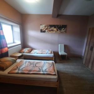 A bed or beds in a room at IKSZT Vendégház Még 10 kép