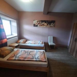 A bed or beds in a room at IKSZT Vendégház