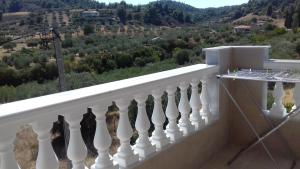 a white railing with a view of a mountain at Apartments Vladimir in Agios Nikolaos