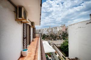 an apartment balcony with a view of a city at WePuglia - Casa sul Ponte in Polignano a Mare