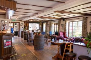a restaurant with couches and tables and chairs at Buffalo Bill's in Halland