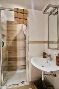 a bathroom with a sink and a shower at B&B Sea and Garden in Orbetello